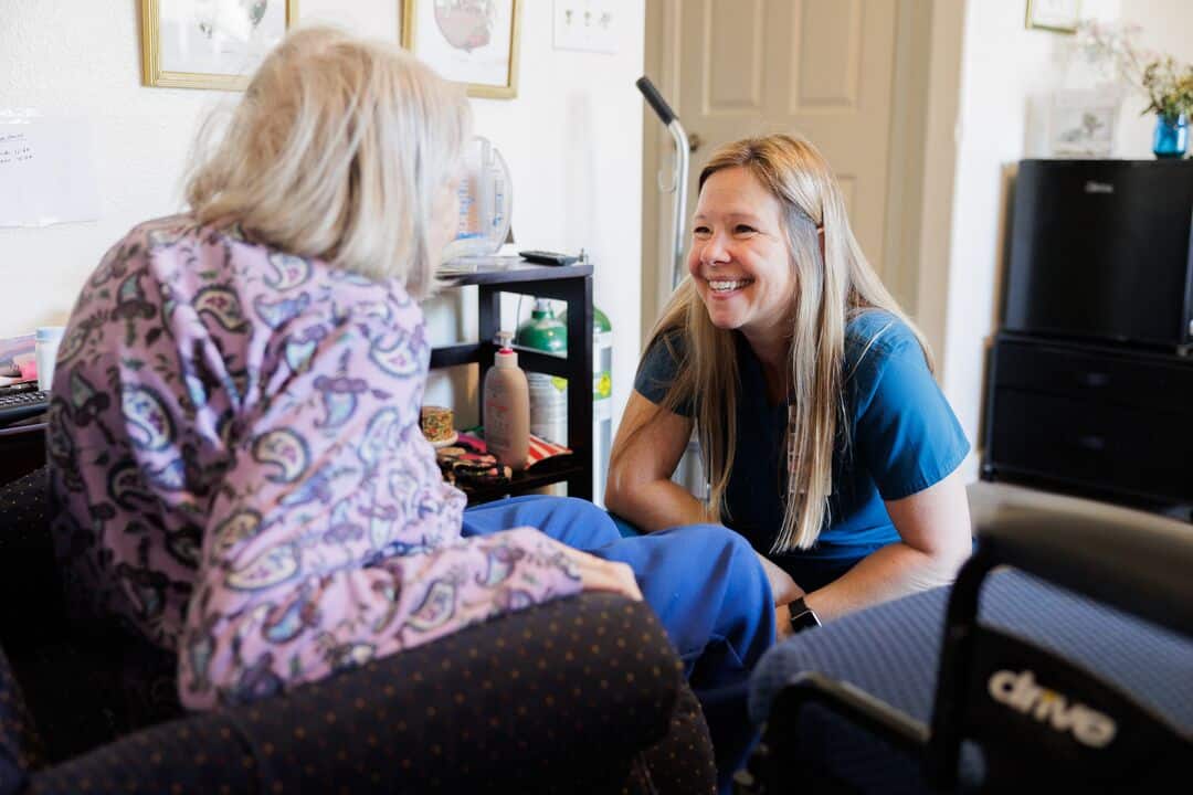 A Home Health nurse smiles at a patient.
